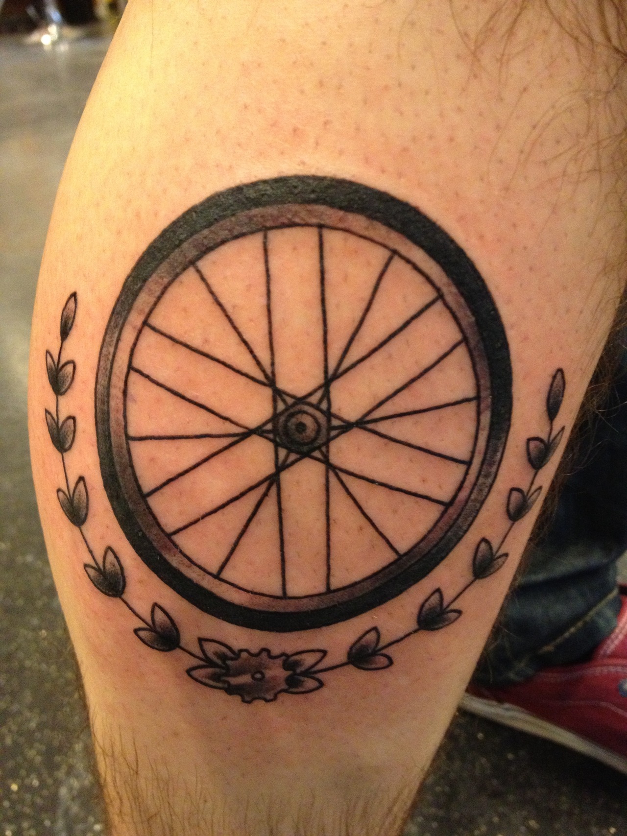 Bike wheel tattoo