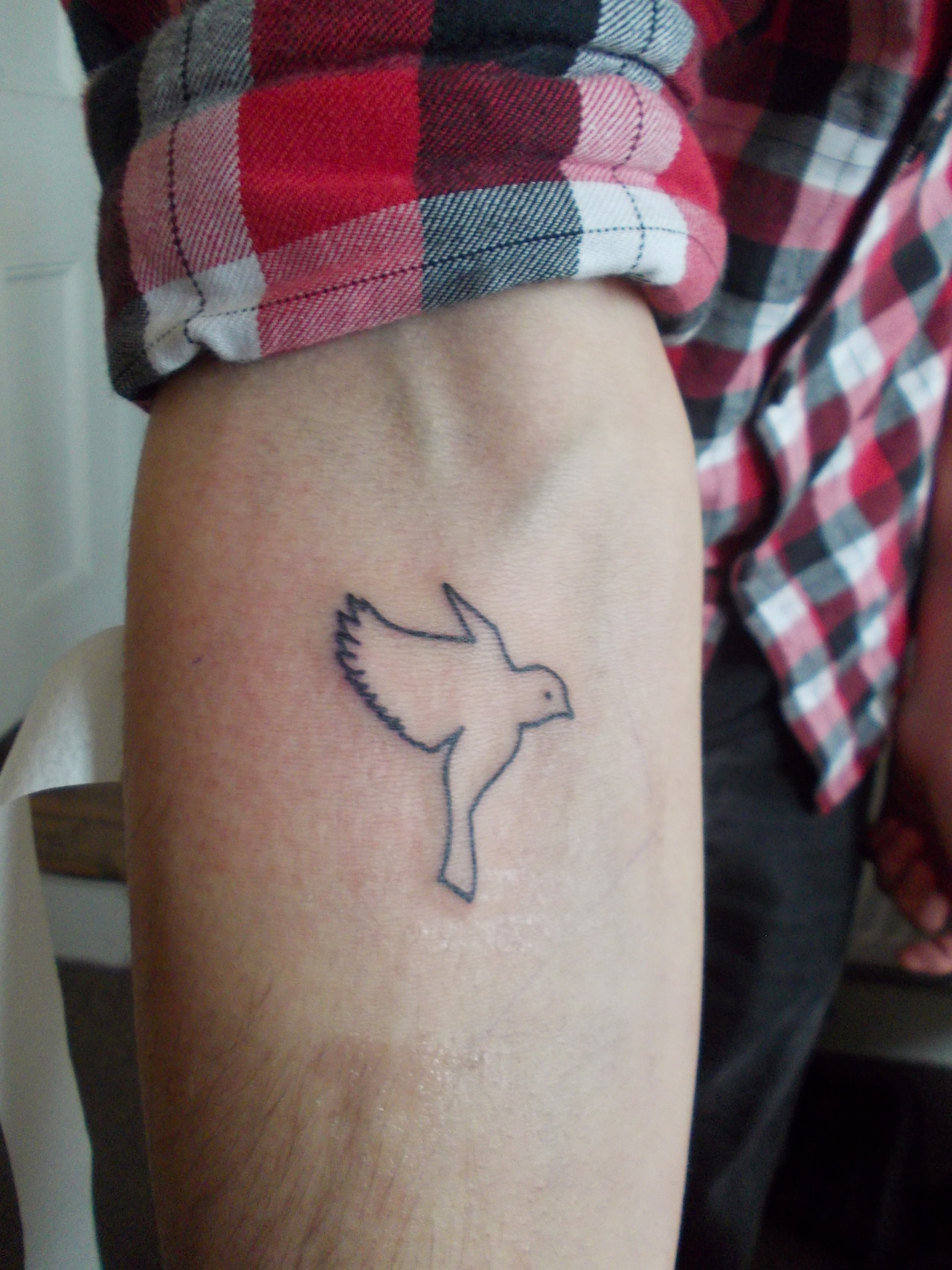 Bird arm tattoo