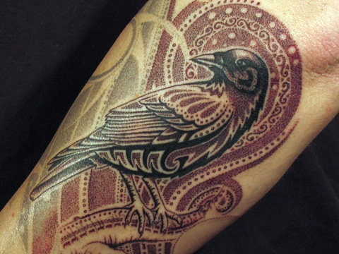 Stylized bird tattoo