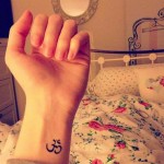 Minimal OM sign wrist tat