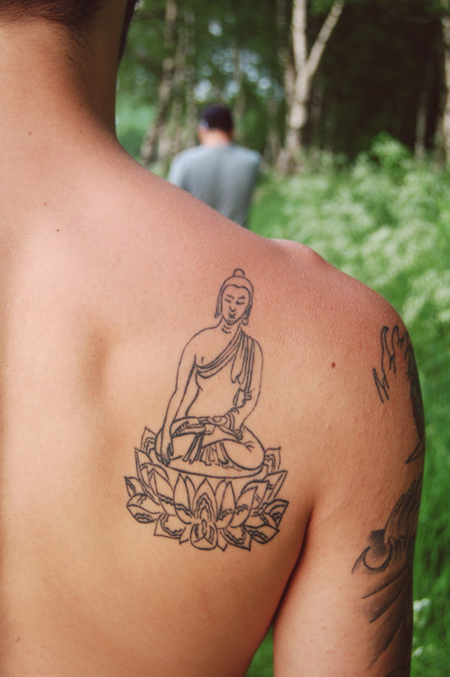 New school Buddha tattoo on the right forearm.
