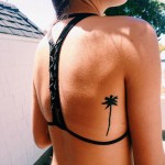 Minimal palm tree tattoo on back