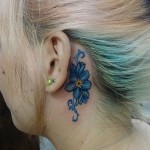 Blue Flower Behind the Ear Tattoo