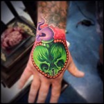 Double skull poison tattoo