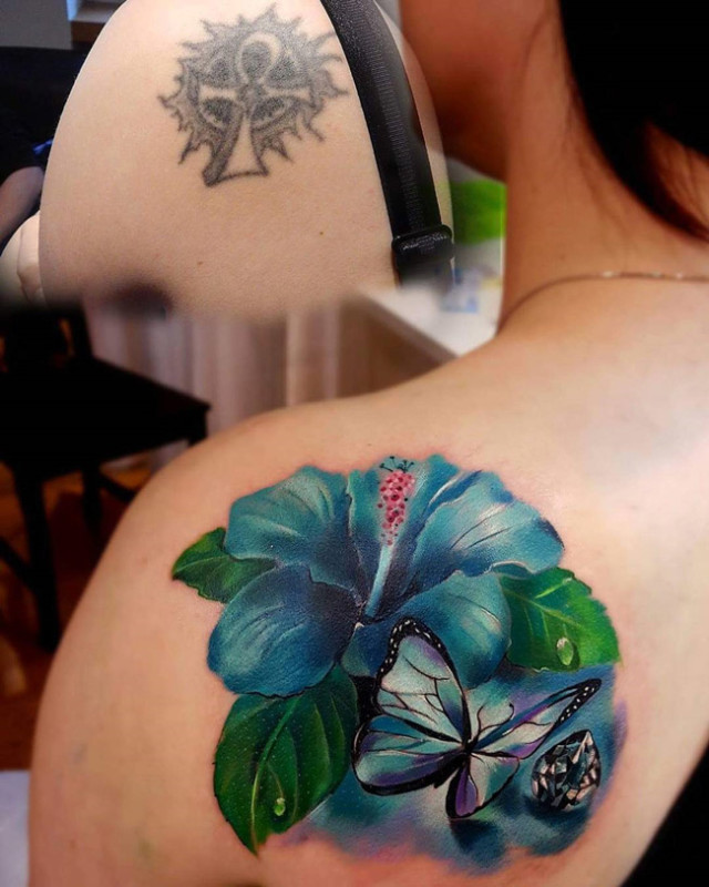 Hibiscus & butterfly shoulder tattoo