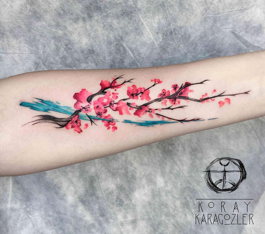 Cherry blossom forearm tattoo by Koray Karagözler. 