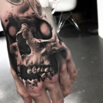 Evil Skull Hand Tattoo