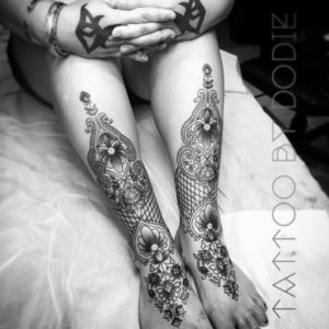 Ornamental matching leg tattoos