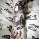 Lighthouse scene black ink foot tattoo
