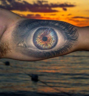 Realistic eye mens bicep tattoo