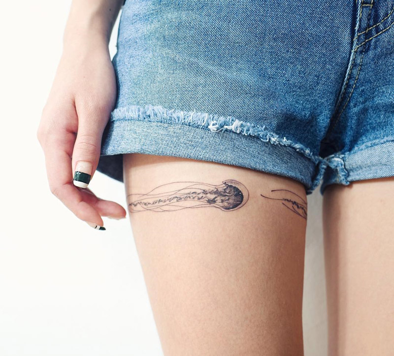Jellyfish girls thigh tattoo