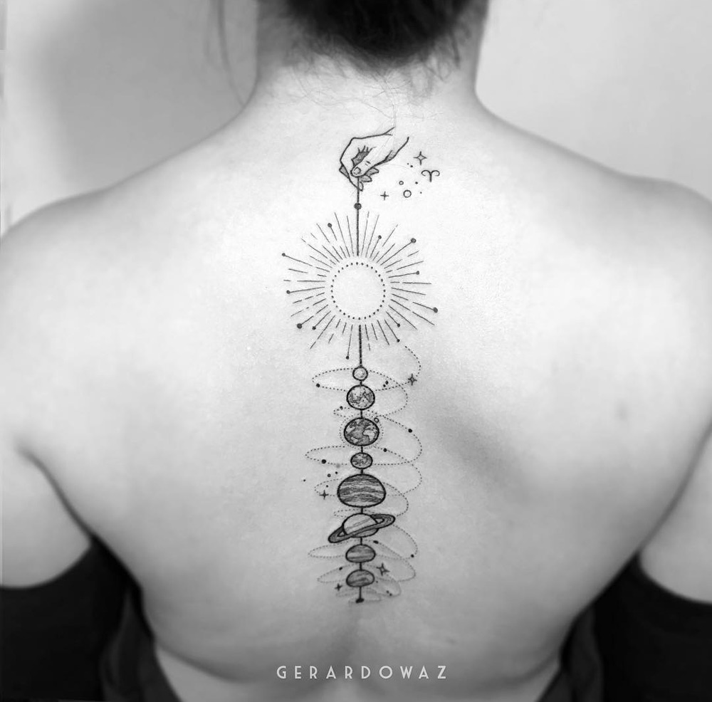 Solar system tattoo on girl's spine