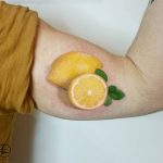 Lemon tattoo, realism men's bicep