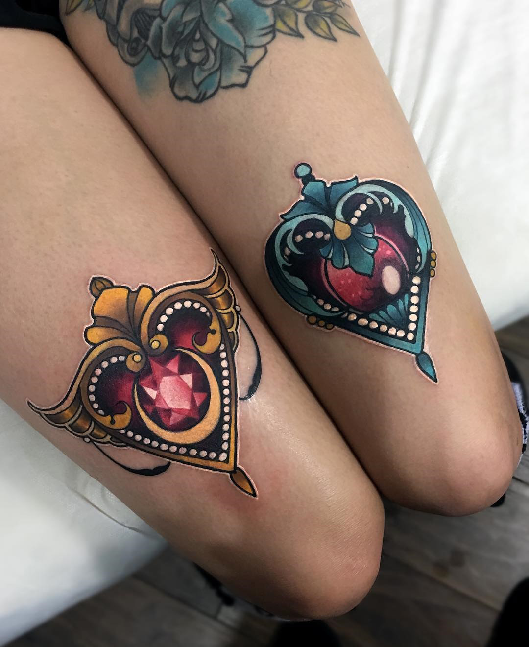 Ornamental hearts double thigh tattoos
