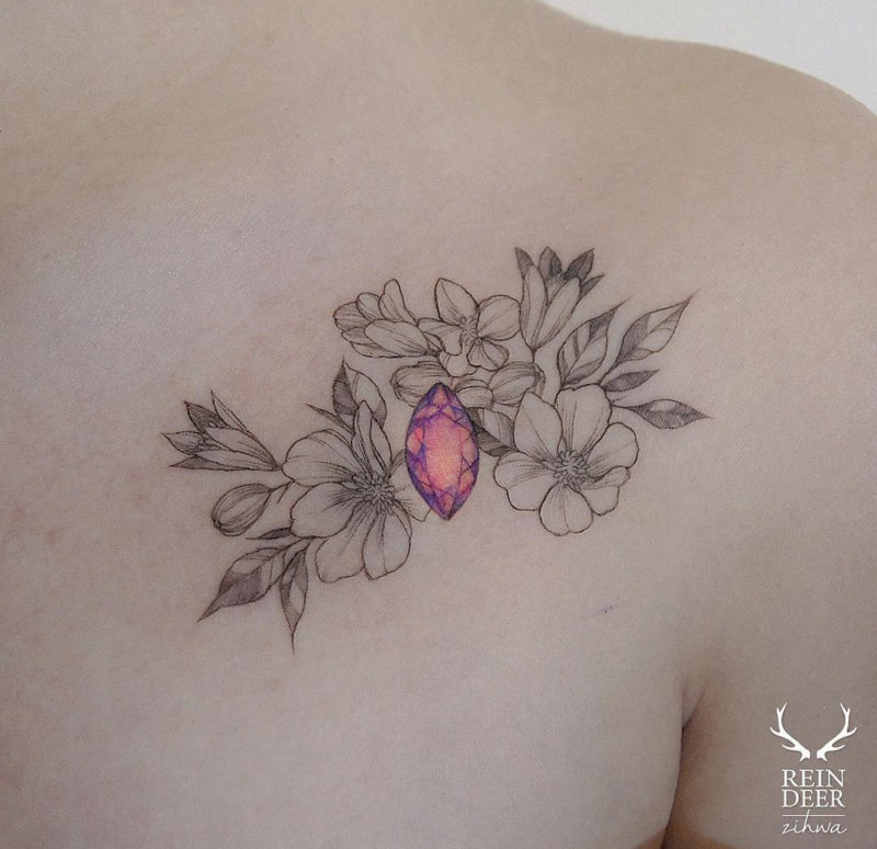 Gem & flowers chest tattoo