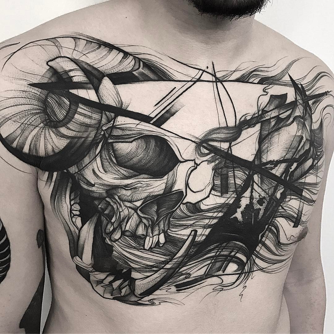 Abstract skull chest tattoo