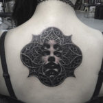 Evil church, girl's back tattoo
