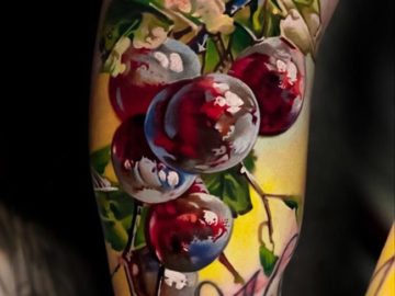 Red grapes arm tattoo