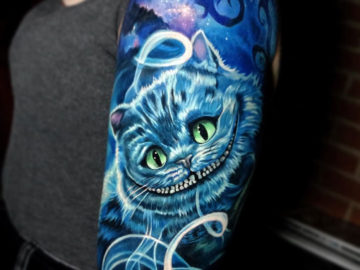 Cheshire cat girl's arm tattoo