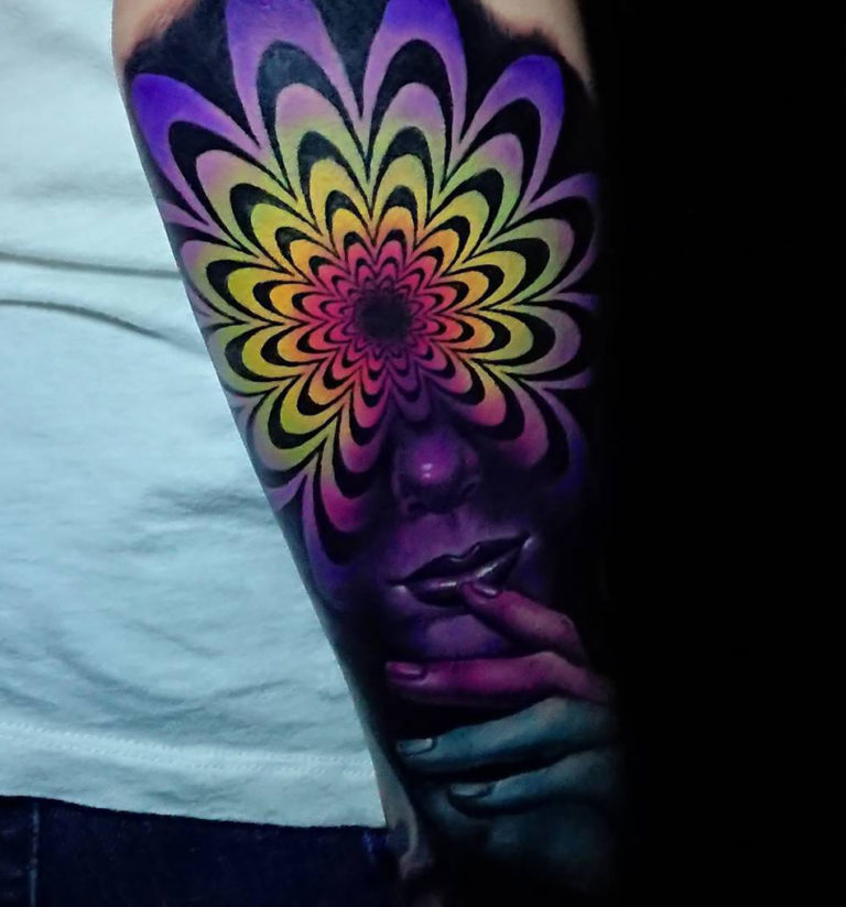Psychedelic fox tattoo on the right inner arm.