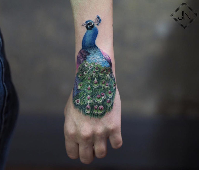 peacock wrist and hand tattoo