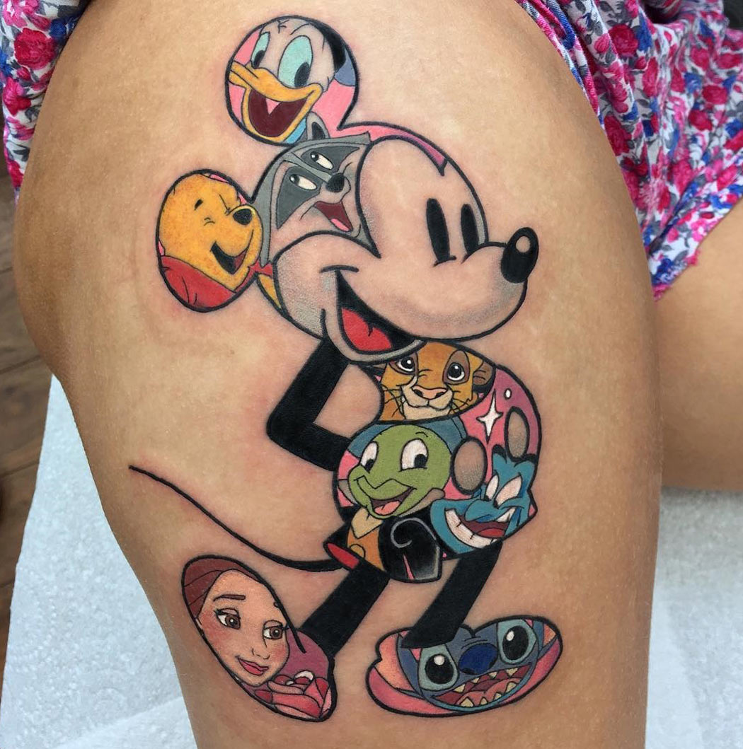 Disney characters thigh tattoo.