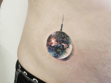 Disco ball tattoo on abs