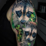 Raccoons arm tattoo
