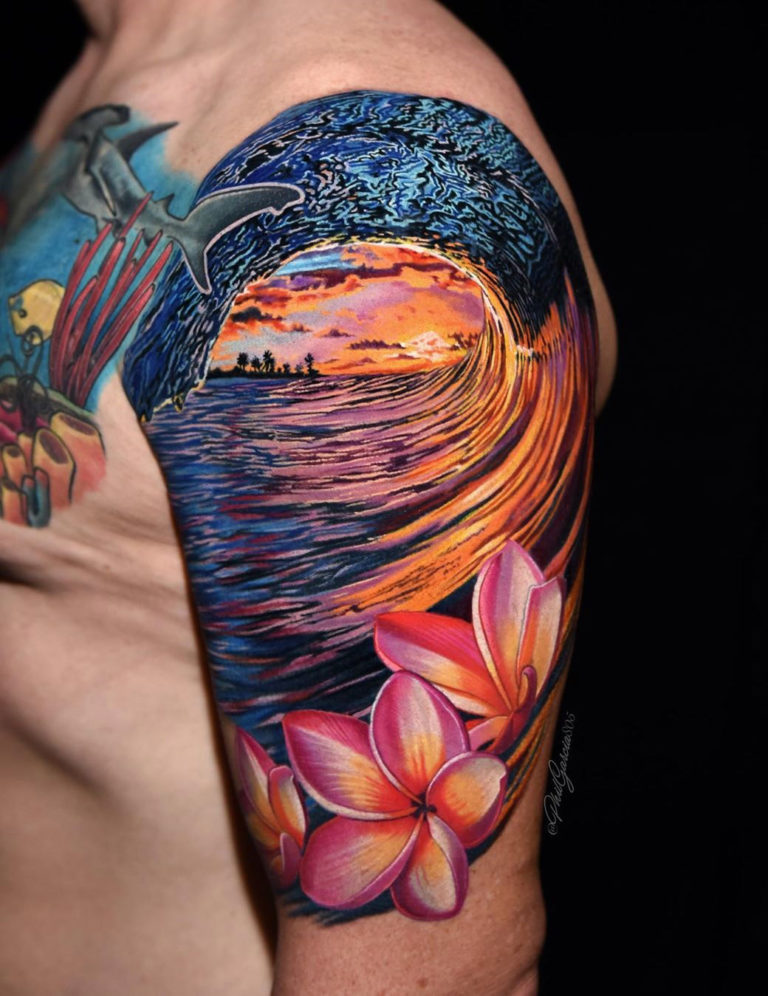 Wave and flowers arm tattoo