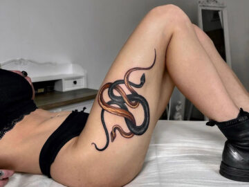 Snakes thigh tattoo