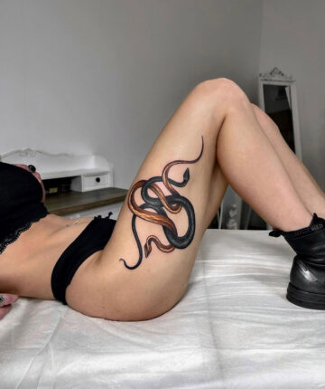 Snakes thigh tattoo